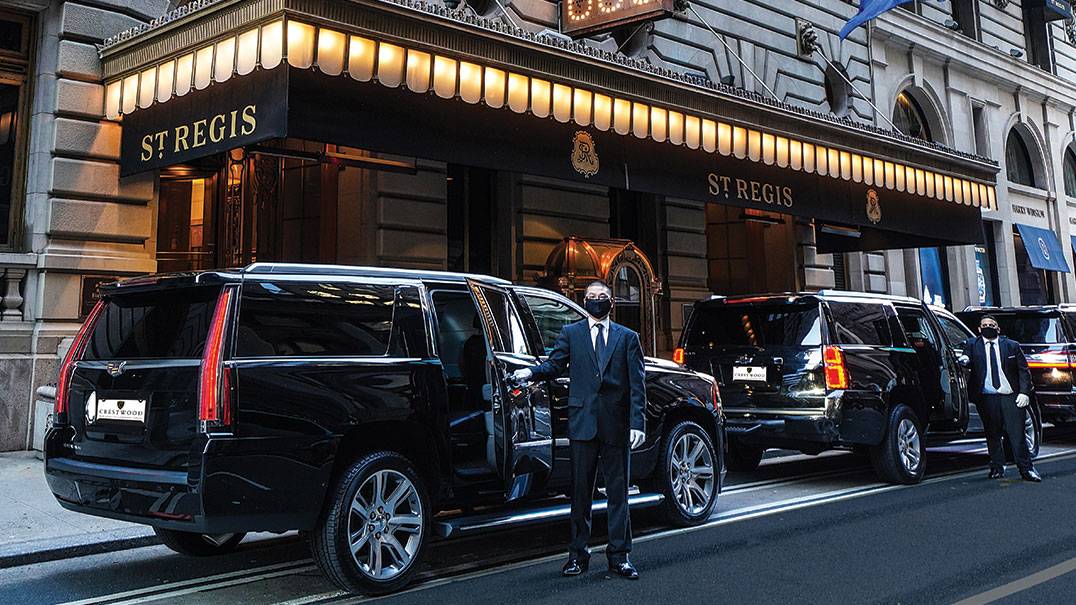 Professional driver assisting passengers during a Miami Airport to Port of Miami transfer.