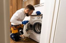 Technician replacing washer parts during Washer Dryer Repair in Downtown